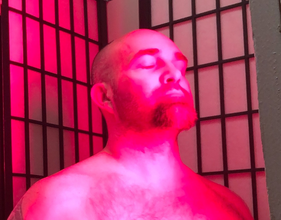 Person relaxing with eyes closed under infrared light